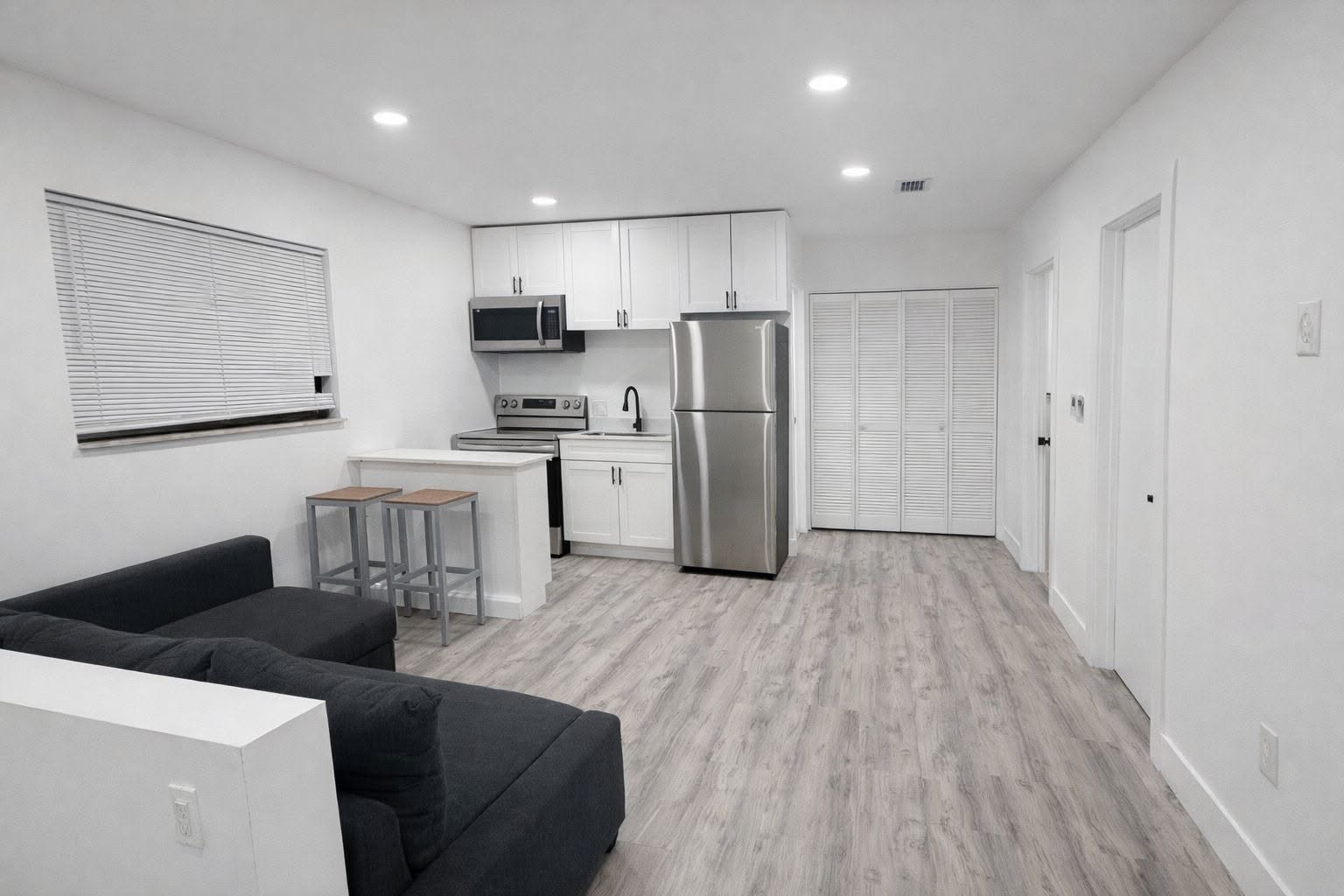 North Miami apartment with open-plan living room and white kitchen